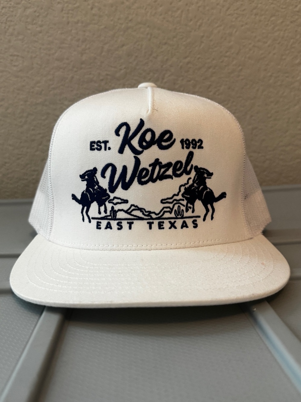 White Trucker Hat with Navy Embroidered Logo